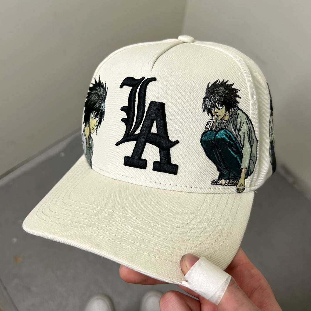 “L”A CAP